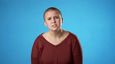 Young worried pleading non binary gender fluid woman 20s hold hands folded in Stock Footage 223260981