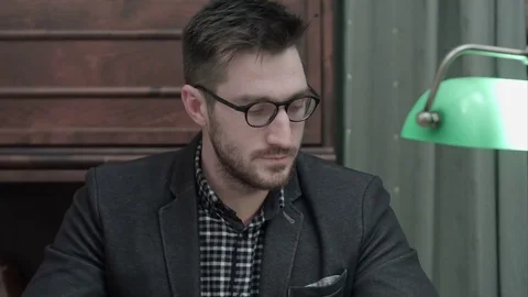 Young writer reading articles and is happy to answer a phone call Stock-Footage 73686705