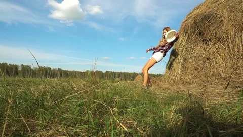 Young Wwoman Falling On Hay Stack 스톡 동영상 76404660
