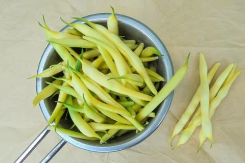 Young yellow string beans collected in a ladle Stock Photos