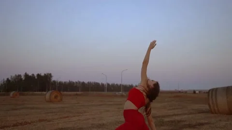 Young yoga instructor relaxing doing warrior pose outdoors, arc shot Stock Footage 233381185