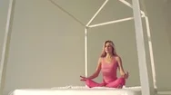 Young Yoga Woman Wearing Pink Sports Cloths Doing Yoga In Bed Stock Footage