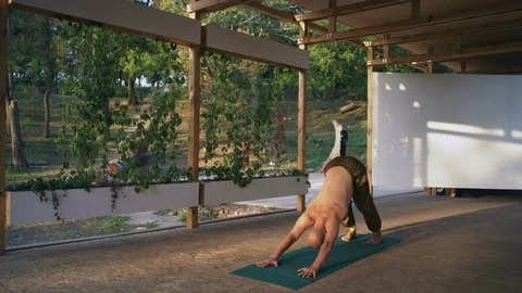 Young Yogi Performs Suryanamaskar Practice on Wooden Pomo in Rano City Park In Stock Footage 85371008