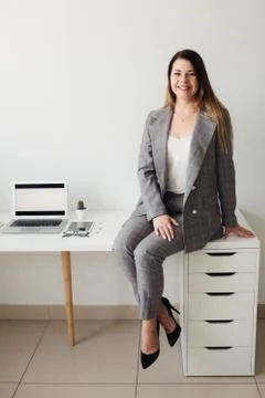 Younger girl working in the office at the table Stock Photos