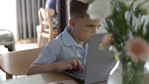 Youngster completely absorbed, fingers dancing over laptop keys. Stock Footage 310938505