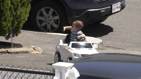 Youngster has fun riding in remote control car Video stock 75583638