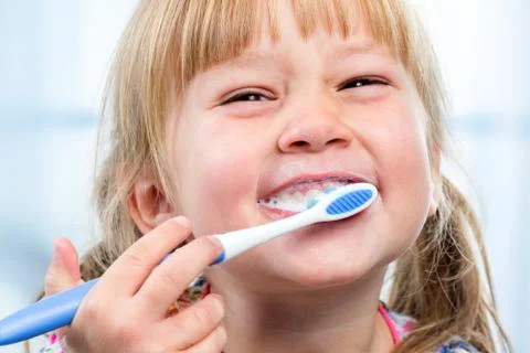 Youngster having fun brushing teeth. Stock Photos