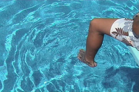 Youngster seated in the swimming pool Stock Footage 105830
