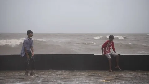 Youngsters enjoy high tidal waves at Worli Seaface 스톡 동영상 76998865