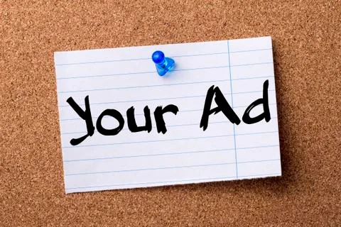 Your Ad - teared note paper pinned on bulletin board Stock Photos