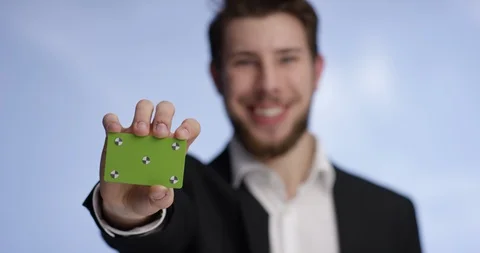 Your buisness card being shown by young and handsome man Stock Footage 99307272