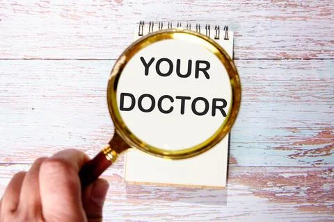 YOUR DOCTOR text seen through magnifying glasses on a notepad Stock Illustration