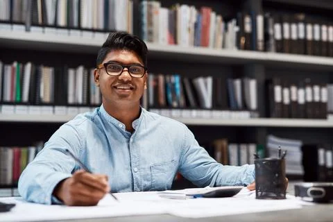 Your dream is my commitment. Shot of a young architect designing a building plan 写真素材