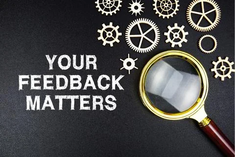 Your Feedback Matters text message with magnifying glass on black background Stock Photos