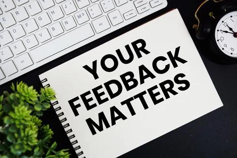 Your Feedback Matters text written on notepad with keyboard and alarm clock.. Stock Photos