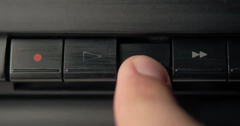 Your finger presses the rewind button then presses the play button. Stock Footage