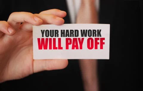 Your Hard Work Will Pay Off inspirational text on card in businessman hand. B 库存照片