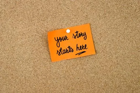 Your Story Starts Here written on orange paper note Stock Photos