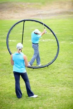 Your swing should stop when you get to here...Image of a male coach instructing Stock Photos