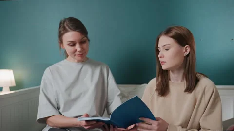 Youth aids learning. Child and guardian sharing peaceful educational moment Stock Footage 336867911