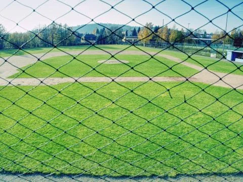 Youth baseball field viewed from behind net Stock Photos