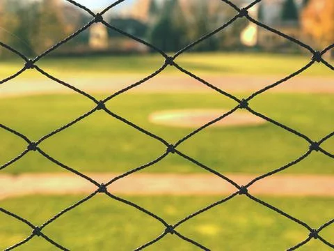 Youth baseball field viewed from behind net Stock Photos