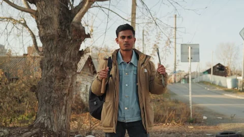 Youth beside tree. Young man awaiting help. Individual by tree seems to wait Stock Footage 334953928