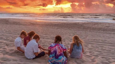 Youth Bible study group on beach  Loopable Stock Footage 161891466