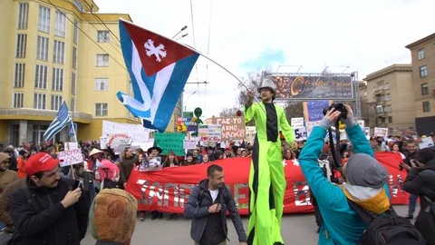 The youth defends his point of view. Crowd of protesters go and shout slogans. Stock Footage 75184865