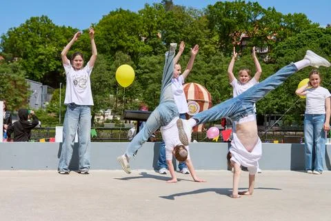 Youth performers practicing acrobatic dance outdoors Stock Photos