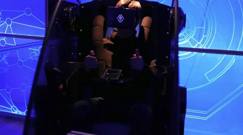 Youth playing a game in 5D simulator with oculus rift and steering control 스톡 동영상 67251342