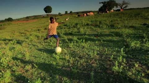 Youth playing soccer on the fields in Africa. Stock Footage