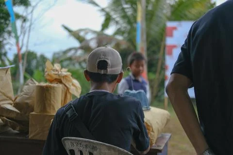 Youth sitting relaxed while preparing prizes for the winners of the competition Stock Photos