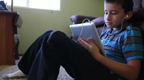 Youth smiling while interacting on tablet 動画素材 12296875