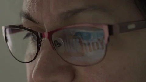 Youtube Logo Reflection in Glasses of Middle Aged Female Video stock 74899253