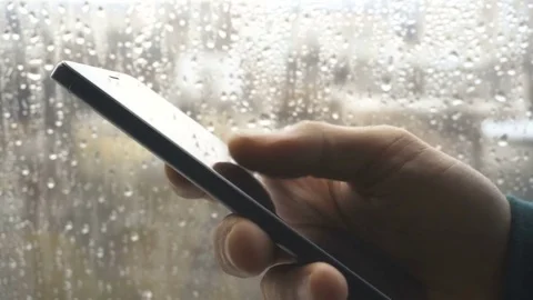 Ypung man browsing information on smartphone with drops on background Stock Footage 83818645
