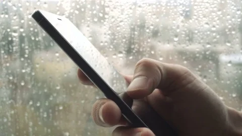 Ypung man browsing information on smartphone with drops on background Stock Footage 84488606