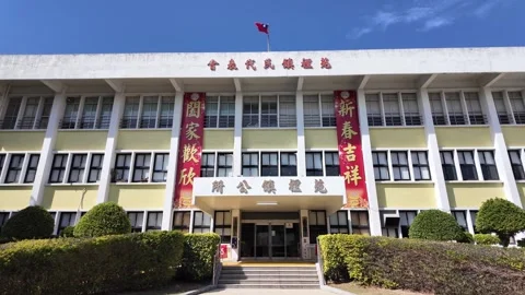 Yuanli Town Representative Assembly building exterior with red banners Vídeos de archivo 345999040