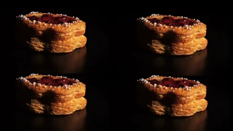 Yummy delicious flavored cake with cherry jam rotates on a dark, black backgr Stock Footage 84736707