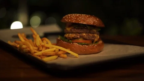 Yummy hamburger on tray with dark background at night Stock-Footage 121075720