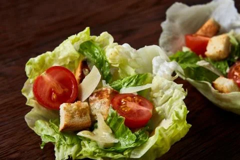 Yummy top view composition of fresh healthy salad served in lettuce leaves on Stock Photos