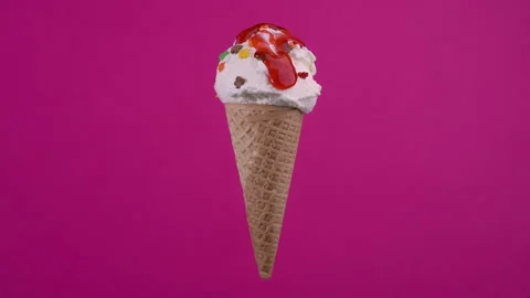Yummy vanilla ice cream in waffle cone and pouring strawberry topping. Sweet Stock Footage 167657237