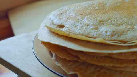 Yummy yellow pancake stack on glass plate. Home cooking steam. Slowmo closeup. Stock Footage 128701143