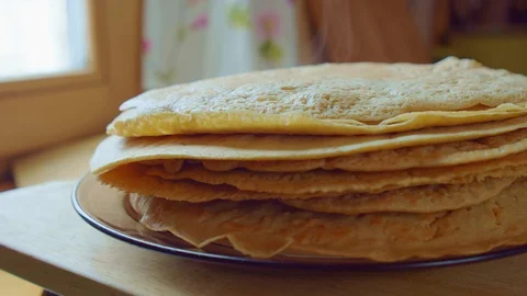 Yummy yellow pancake stack on glass plate. Home cooking steam. Slowmo closeup. Stock Footage 128701172