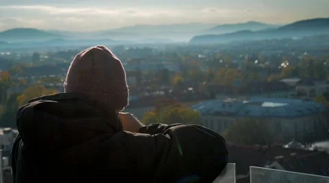 A yung man is looking over the city blocks as he is exploring it Stock Footage 56242597