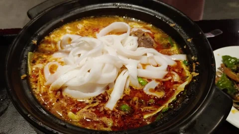 Yunnan-style beef and egg rice noodles in a steaming pot Stock Footage 342282965