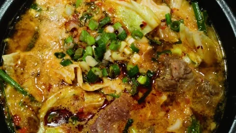 Yunnan-style beef and egg rice noodles in a steaming pot Video stock 342283014