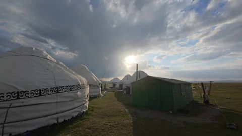 Yurt camp under a dramatic sky at Song-Kol, Song-Kol Lake, Kyrgyzstan Stock Footage 347242682