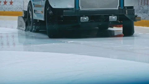 Zamboni resurfacing an indoor skating rink. Slow Motion. Ice resurfacer cleaning Stock Footage