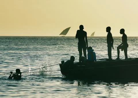 Zanzibar boys swimming in the bay splash Stock Photos